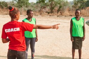 Christine,  a young Restless Development trained volunteer demonstrates her idea for an HIV/football drill during a football match in Katube, Mkushi District Zambia. 
