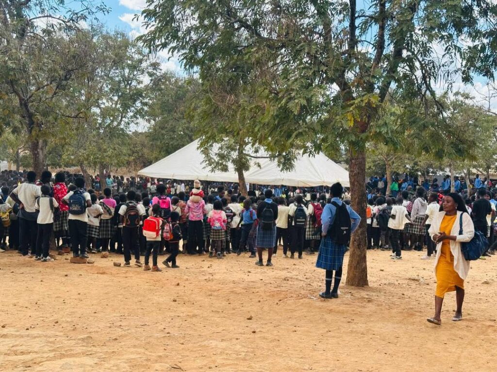 large group of pupils gathered around a tent