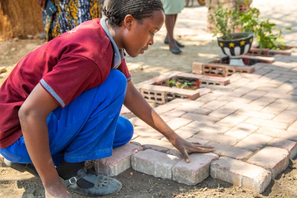 Pupil installing pavers