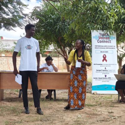 Young facilitator and ministry representative talking at youth/health Indaba