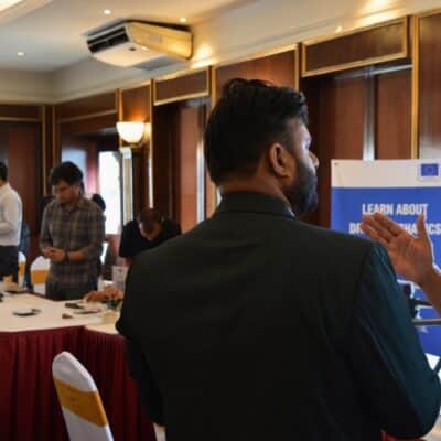 CODE Project team member engaging with a participant during the project launch event.
